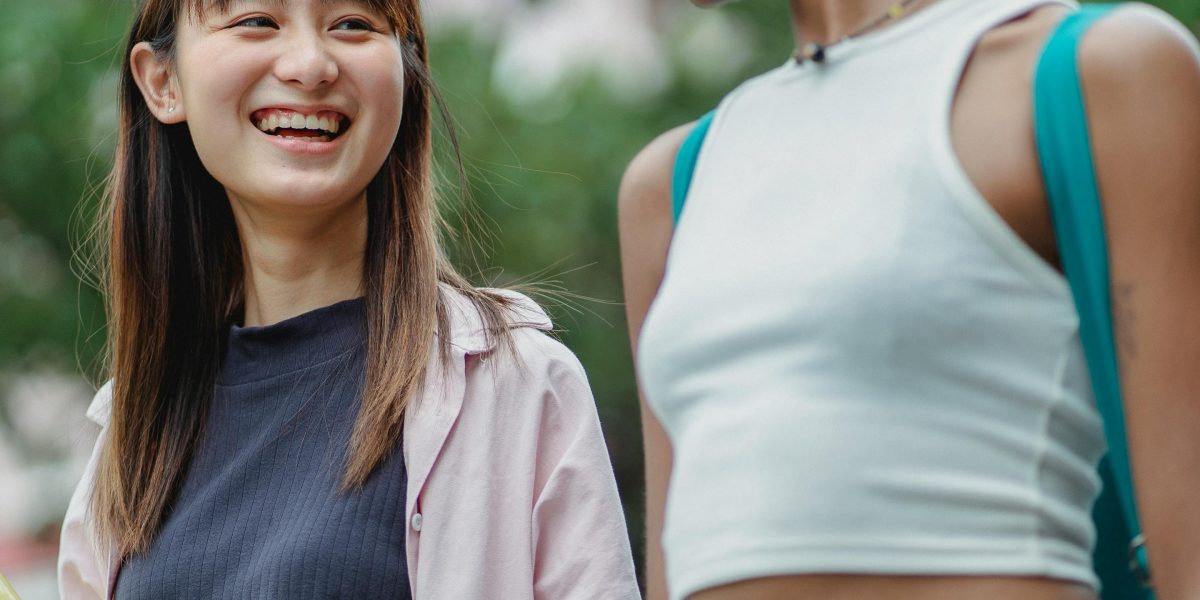 High school students engaging in activities on a vibrant college campus, experiencing pre-college life during a summer program.
