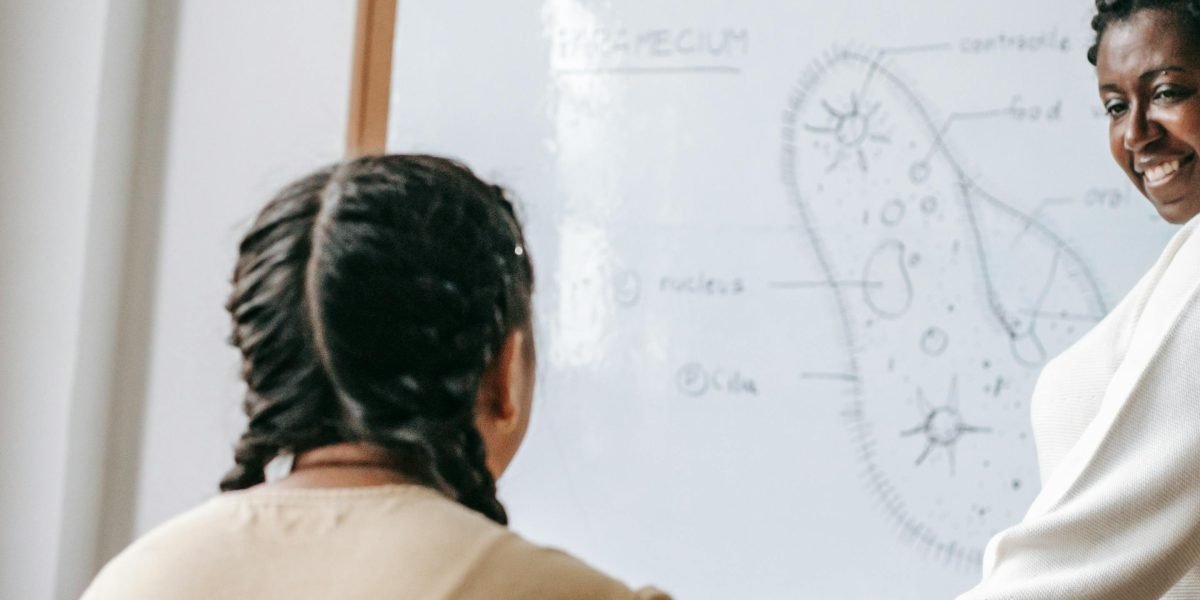 A dedicated teacher thoughtfully organizes lesson plans, focusing on strategies to enhance student memory and engagement.