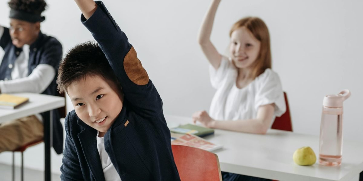 A curious student actively participates in a classroom discussion, demonstrating the importance of attention for effective encoding.