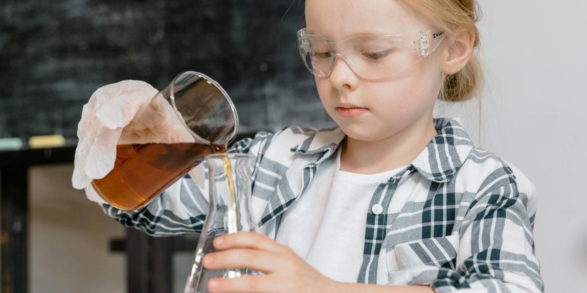 A child enthusiastically conducting a science experiment, connecting learning with sensory experience.