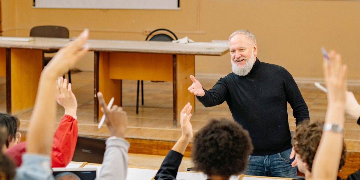 A teacher engaging students in a lively classroom discussion, illustrating effective teaching methods.