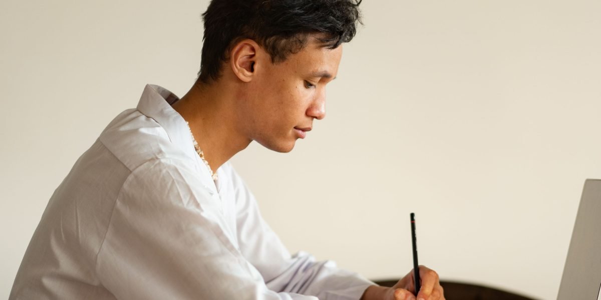 An individual focused on online learning, symbolizing skill development and formal training in UX design.