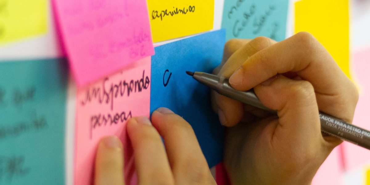 An individual focused on creating a mind map, visually connecting various concepts to deepen their understanding.