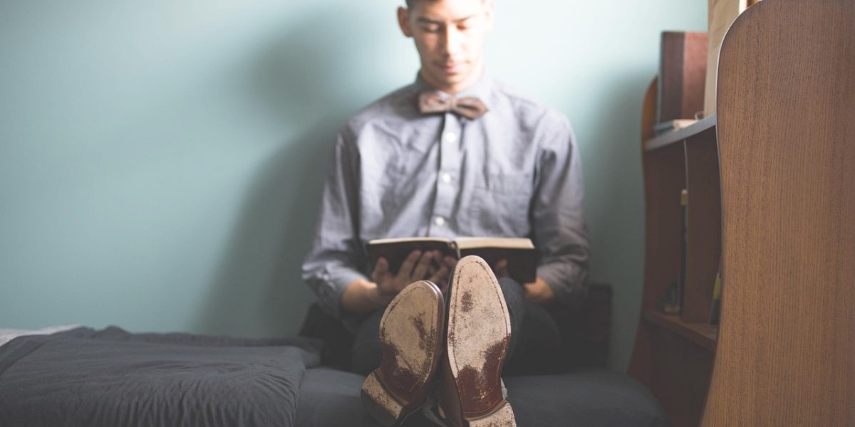 A student thoughtfully browsing a catalog or online system, exploring course options.
