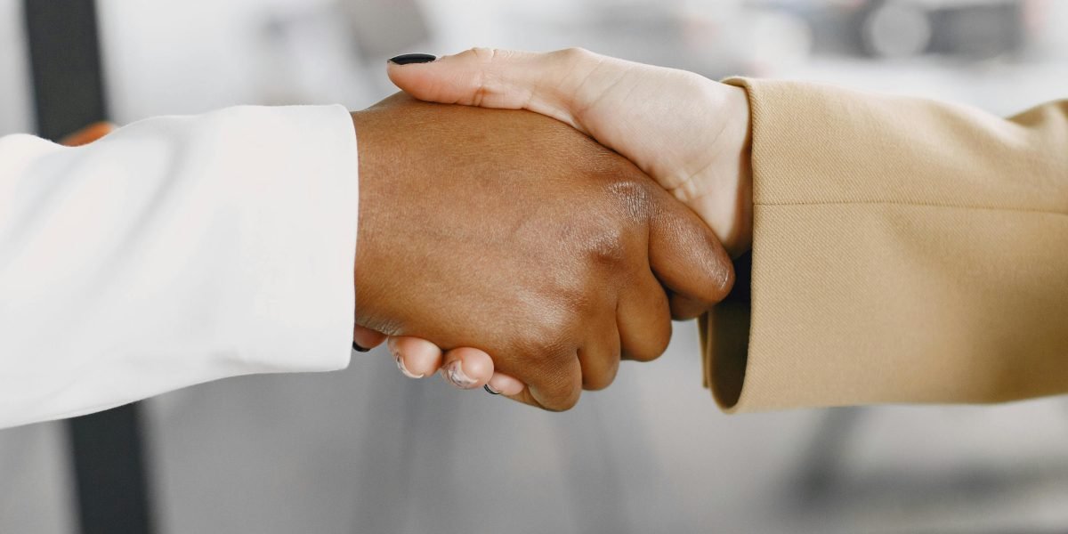 Two professionals shaking hands, symbolizing career opportunities and successful job placements for BSCS graduates.