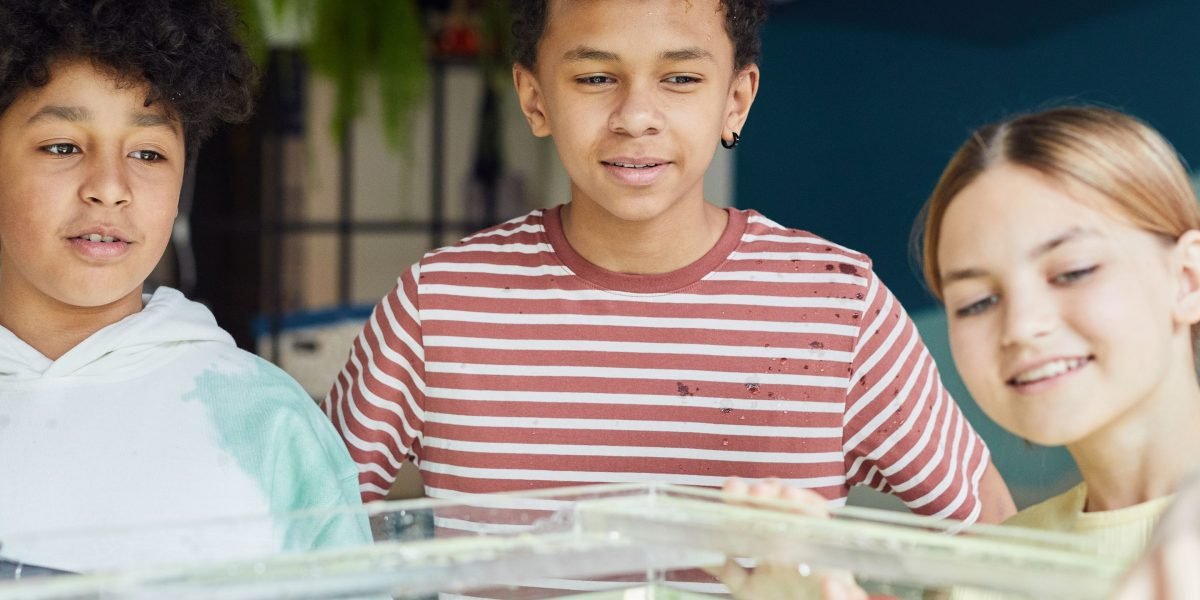 Children actively participate in a hands-on science experiment, fostering deeper engagement and memory.