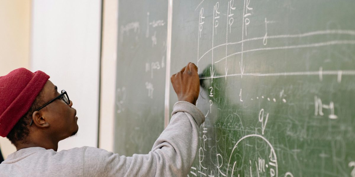 Students engaged in a learning environment, focusing intently on complex scientific concepts.