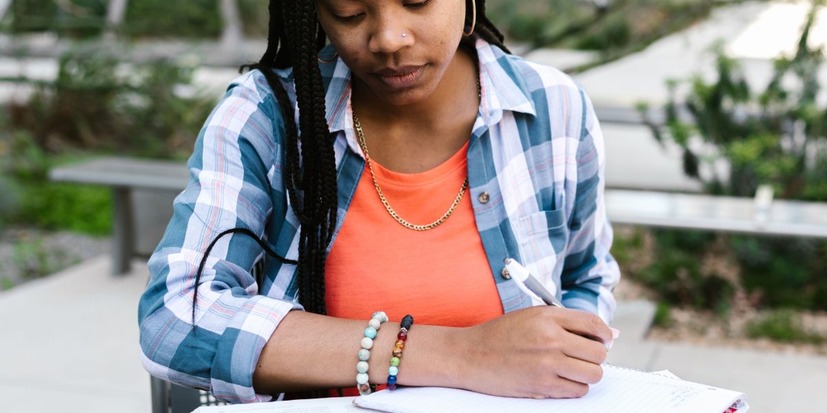 A student engaged in active learning, perhaps self-quizzing or explaining concepts aloud.