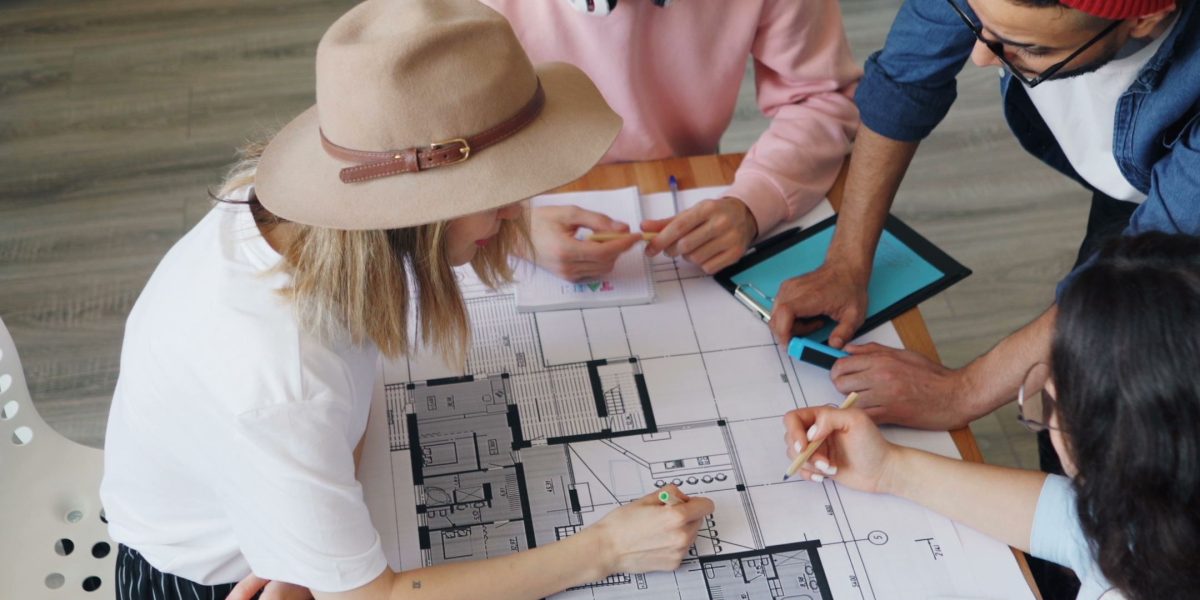 Individuals collaborating to design effective learning experiences with memory principles in mind.