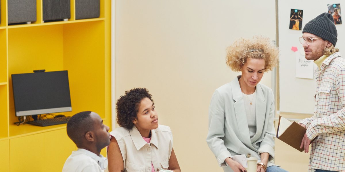 A diverse team actively collaborating, symbolizing the combined strength of group and individual learning.