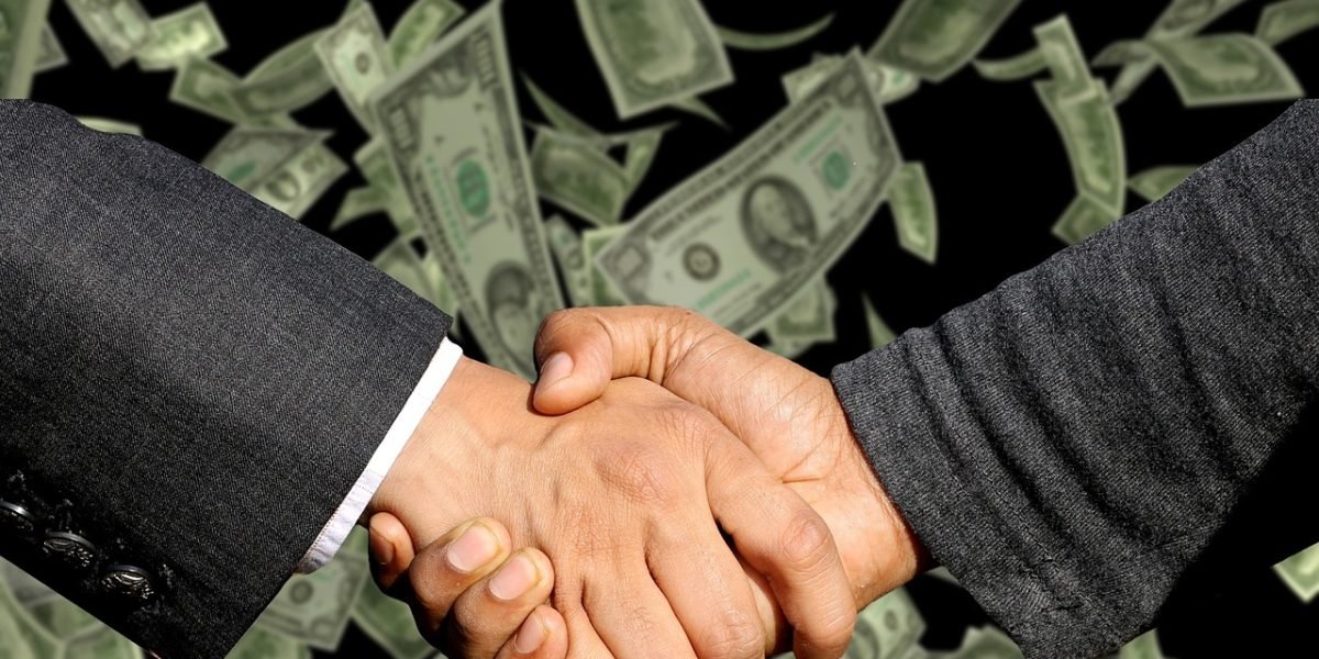 A professional shaking hands with a new colleague or manager, representing career advancement and success from upskilling.