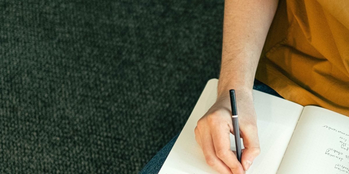 A student engaged in active learning, taking notes in a stimulating classroom or study environment.