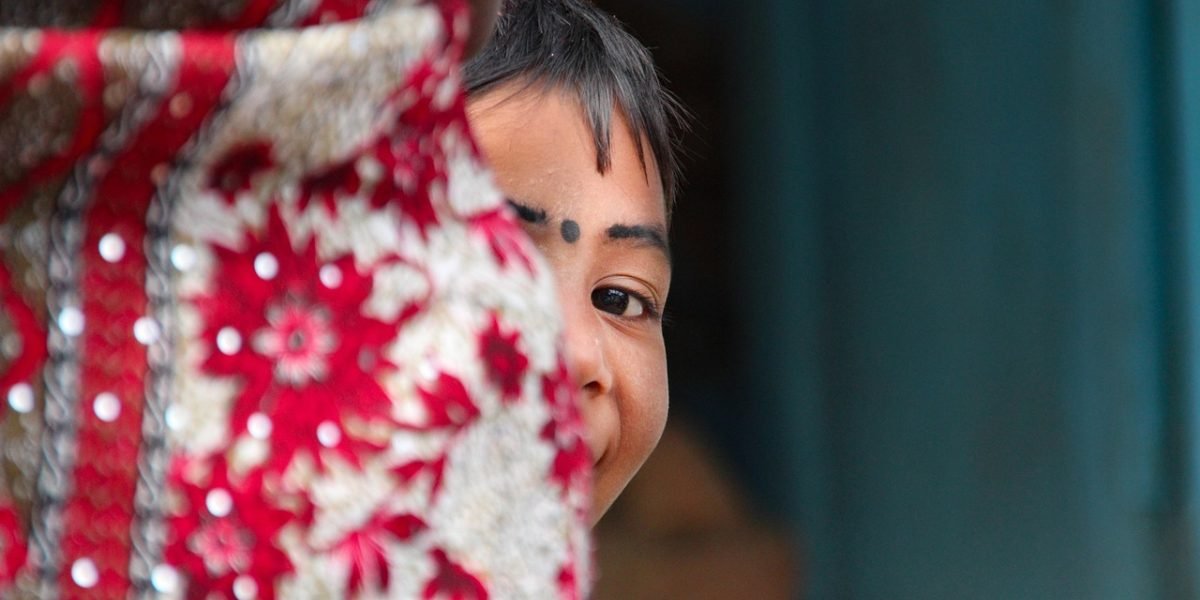 A researcher observing a child's play, representing the in-depth study of child psychology.