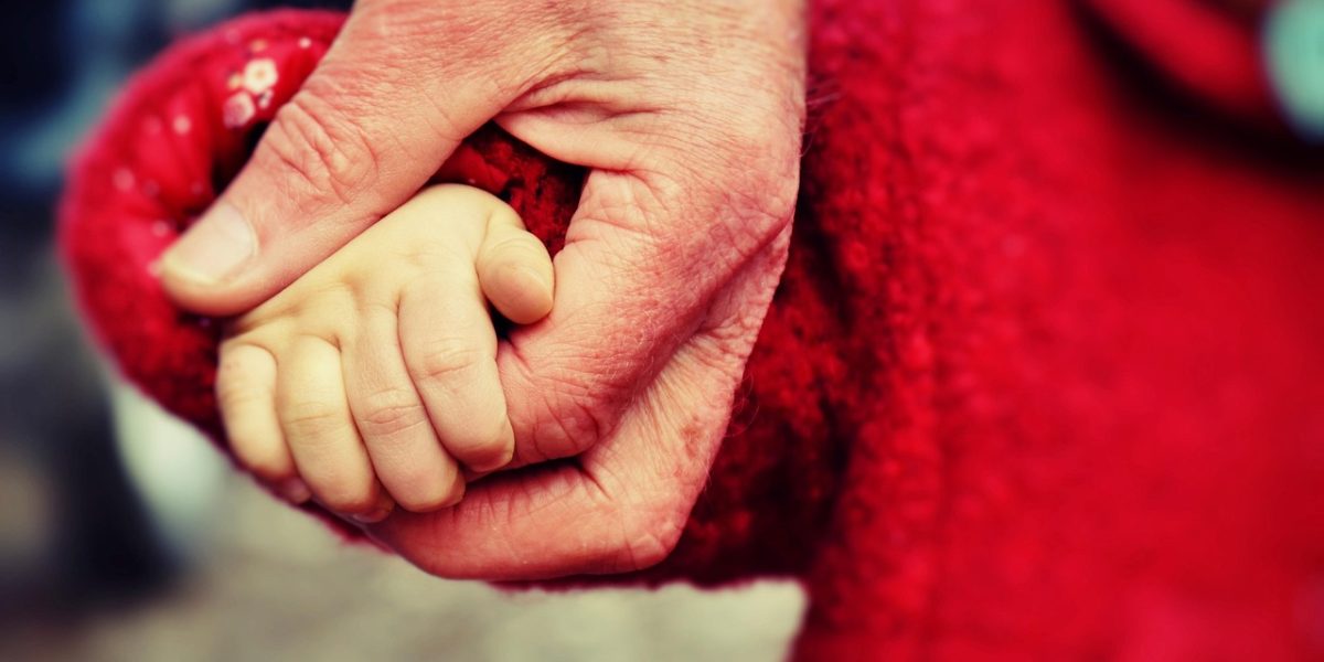 A caring adult provides patient guidance to a child during a learning activity, fostering a positive and supportive environment.