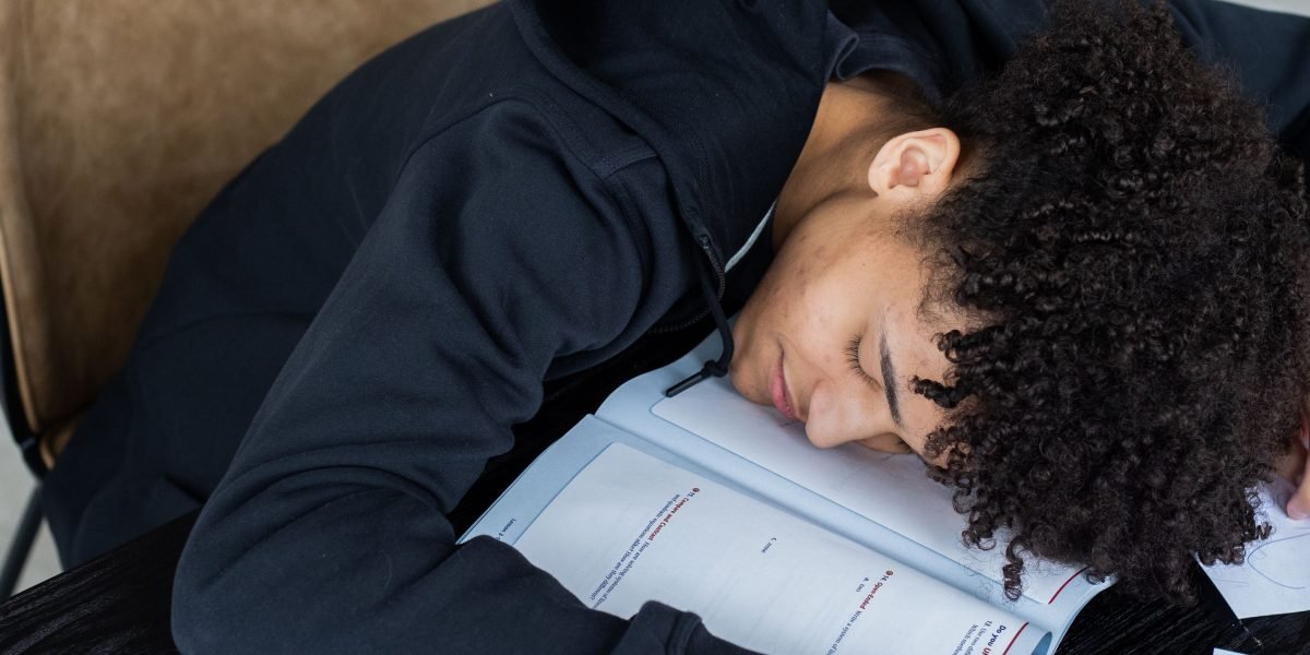 A student looking thoughtfully or slightly frustrated, representing the initial challenge of finding focus amidst many distractions.
