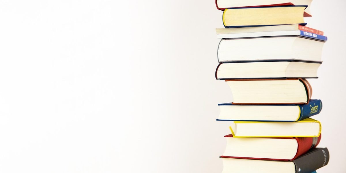 A person focused on reading or analyzing documents, possibly in a library or a quiet study space, representing deep academic research.