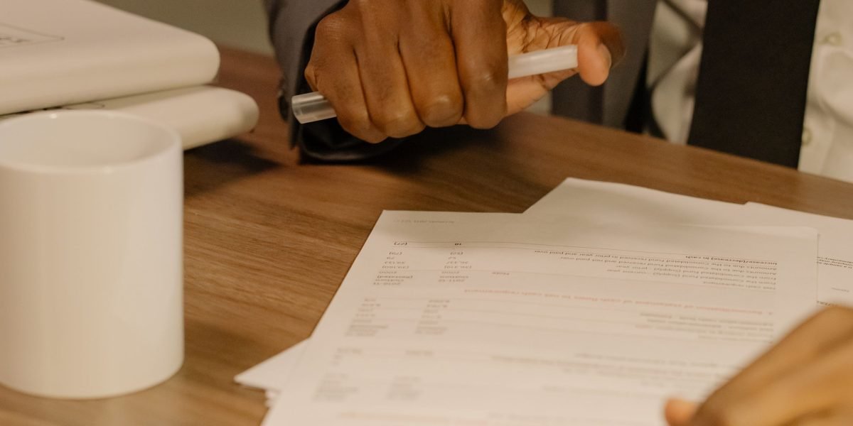 A professional meticulously reviewing documents, representing the careful evaluation of program criteria.