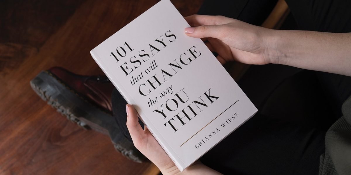 A student looking thoughtfully at a book, embodying the curiosity essential for deep learning and exploration.