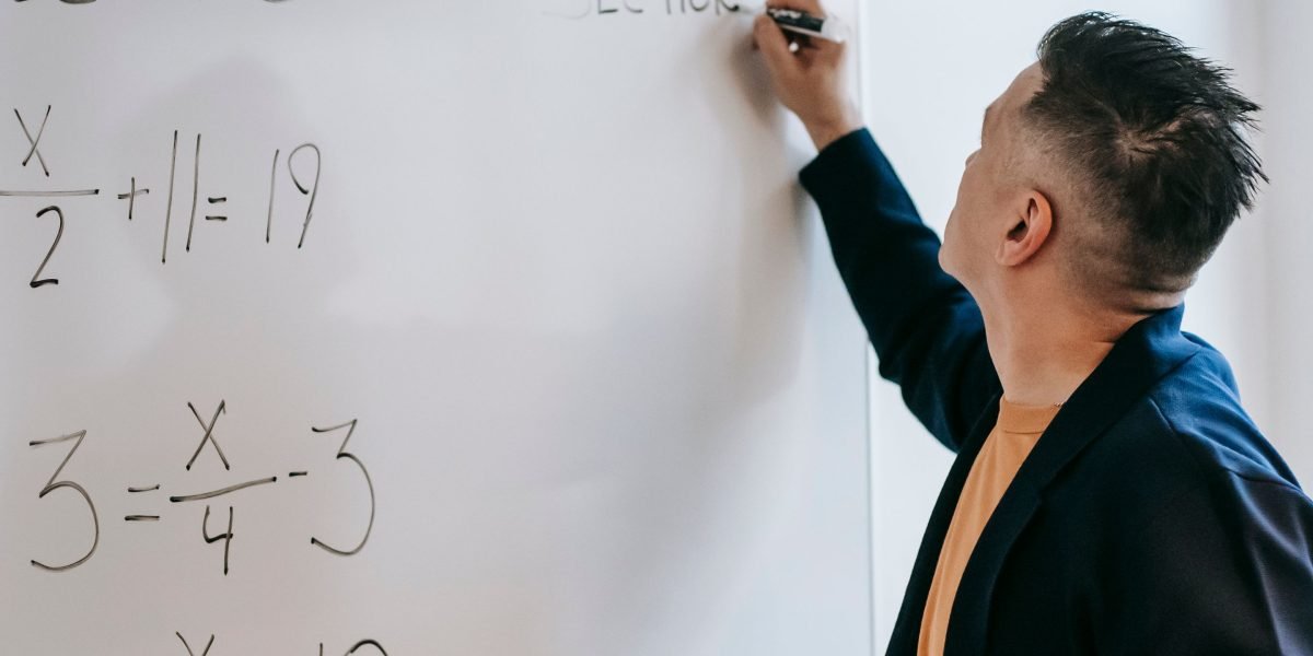 An individual deeply focused on problem-solving, symbolizing the critical thinking required to navigate complex academic challenges.