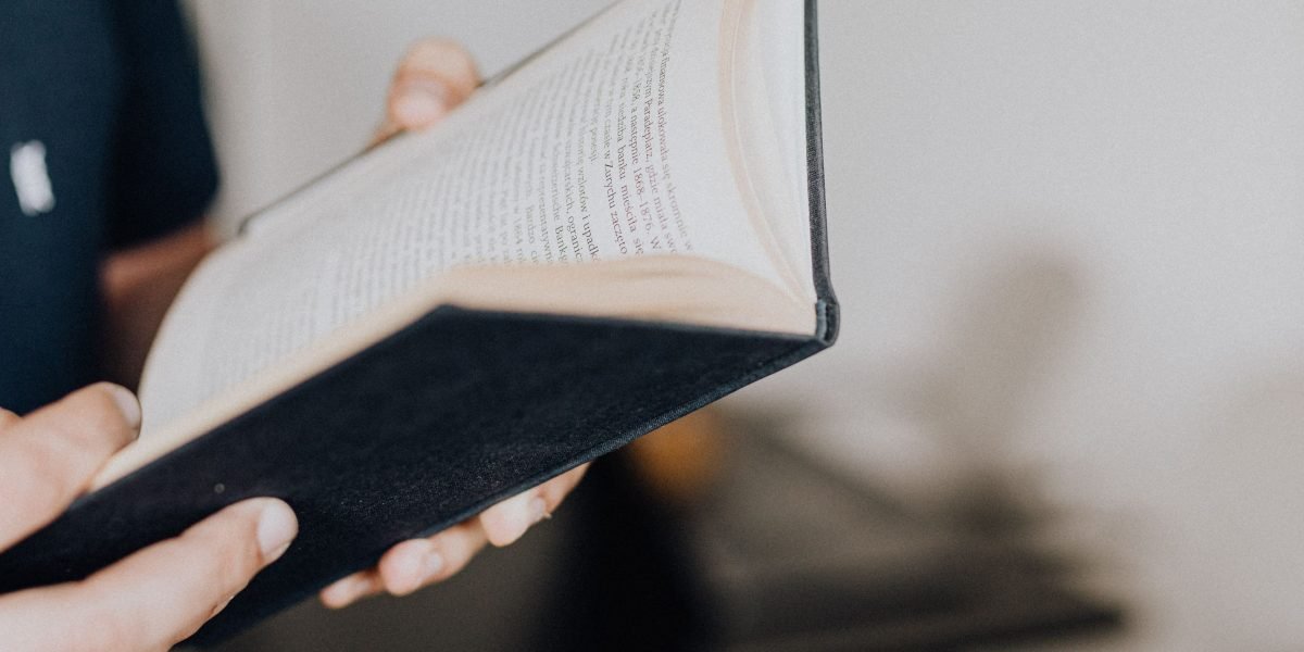 A person engaged in thoughtful reading, symbolizing the search for trustworthy information.
