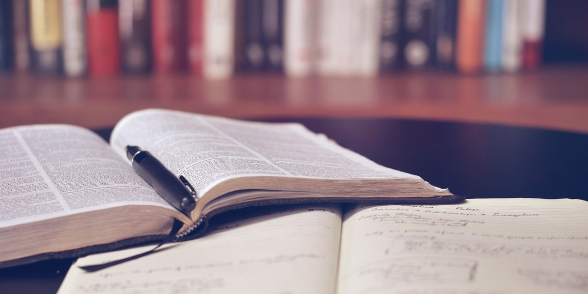 An educator thoughtfully reviewing various free science curriculum materials to ensure quality and relevance for their students.