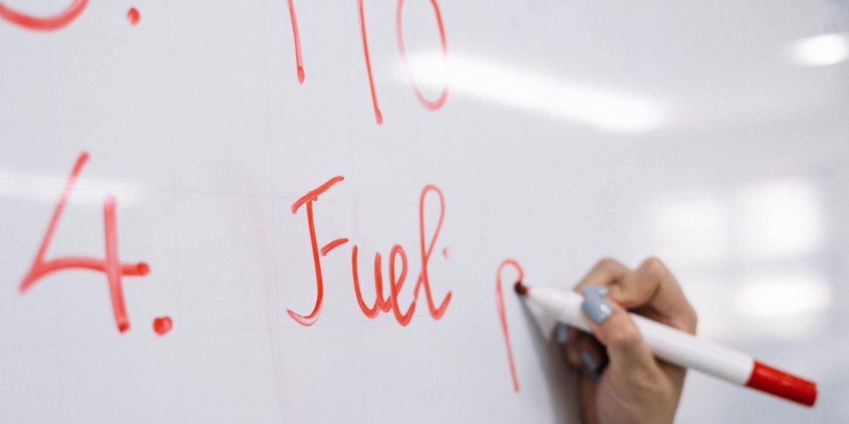 An educator actively brainstorming and organizing ideas on a whiteboard, symbolizing the experimental and iterative nature of teaching in a learning lab.