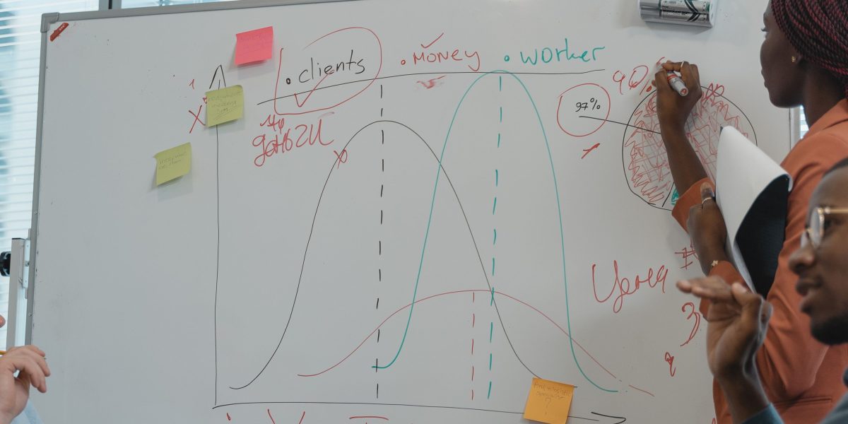 A team of professionals collaborating and discussing strategic plans, representing the organizational effort and planning needed for scaling educational initiatives.
