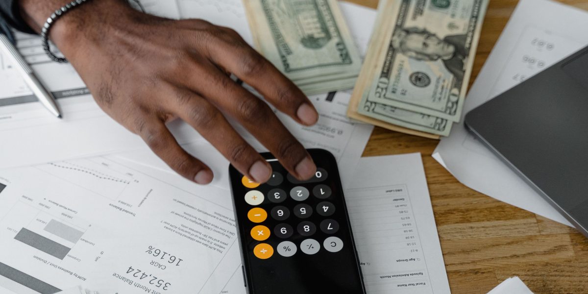An individual meticulously reviewing various financial documents and options related to educational investments.